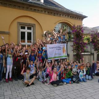 Ferienkinder mit Flagge Biologische Vielfalt